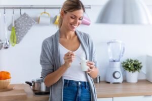 woman eating yogurt after All-on-4 surgery