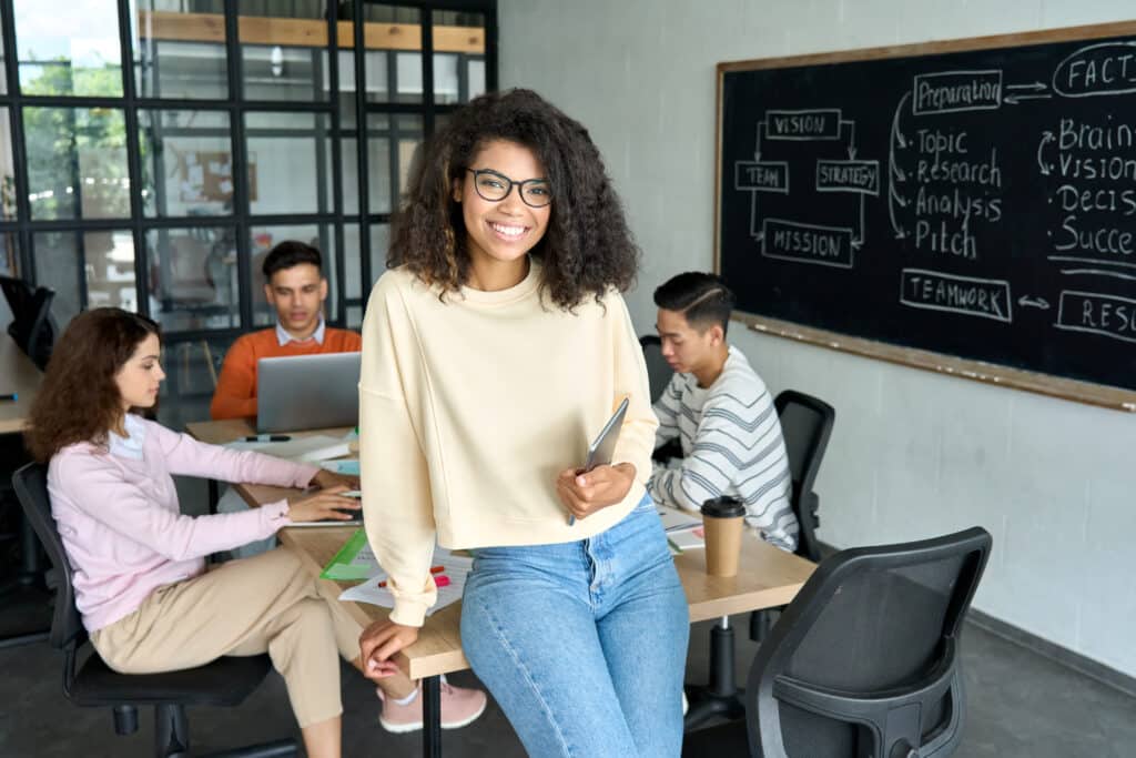 Young,Happy,African,American,Woman,Team,Leader,Sitting,On,Desk