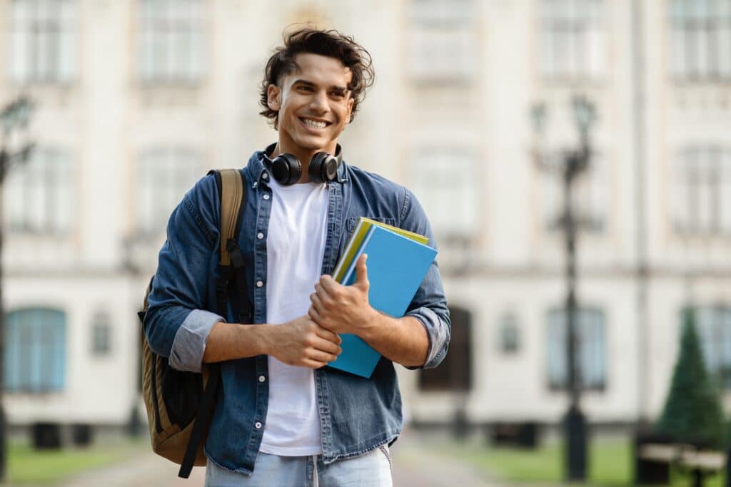 College,Scholarships.,Outdoor,Portrait,Of,Cheerful,Male,Student,With,Backpack